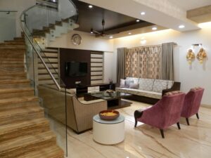 Elegant living room with stylish furniture, marble stairs, and modern decor.